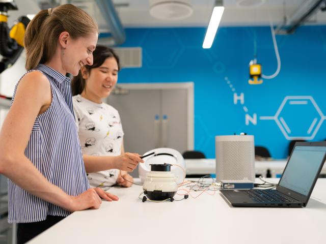 Two women working together at a lab bench